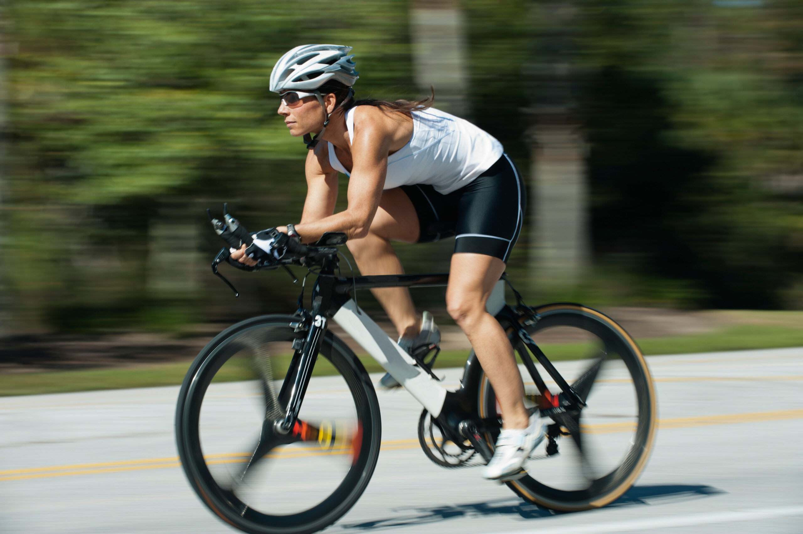 Woman riding road bike, blurred motion